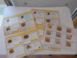 メニューの写真が載っている冊子の中の好きなメニューに丸い小さなシールを貼っています。